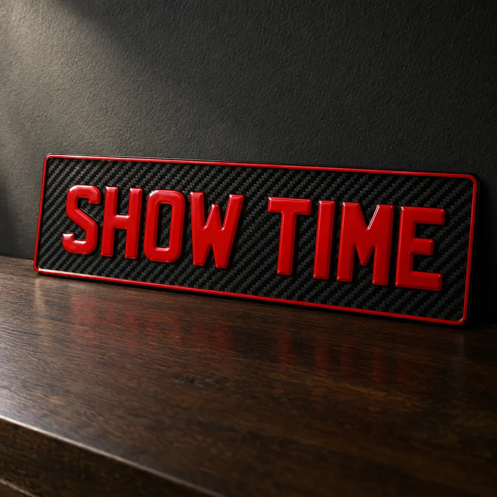 Carbon fibre show plate with red raised characters reading SHOW TIME