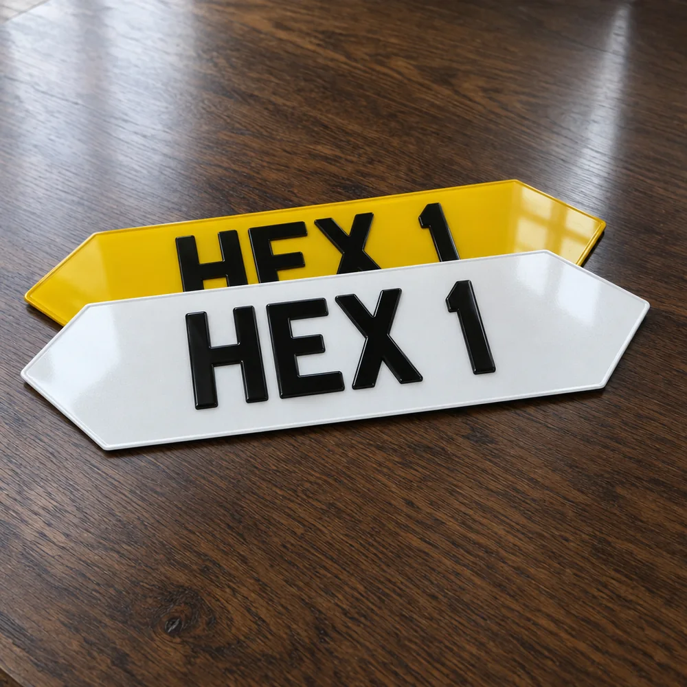 White and yellow hexagon-ended number plates reading HEX 1